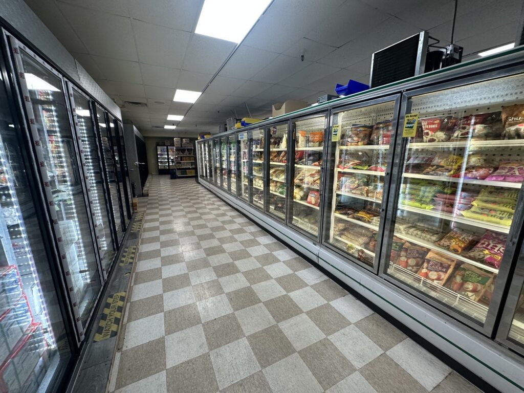 Long freezer aisle with glass doors at Vaphual Asian Market in Tulsa
