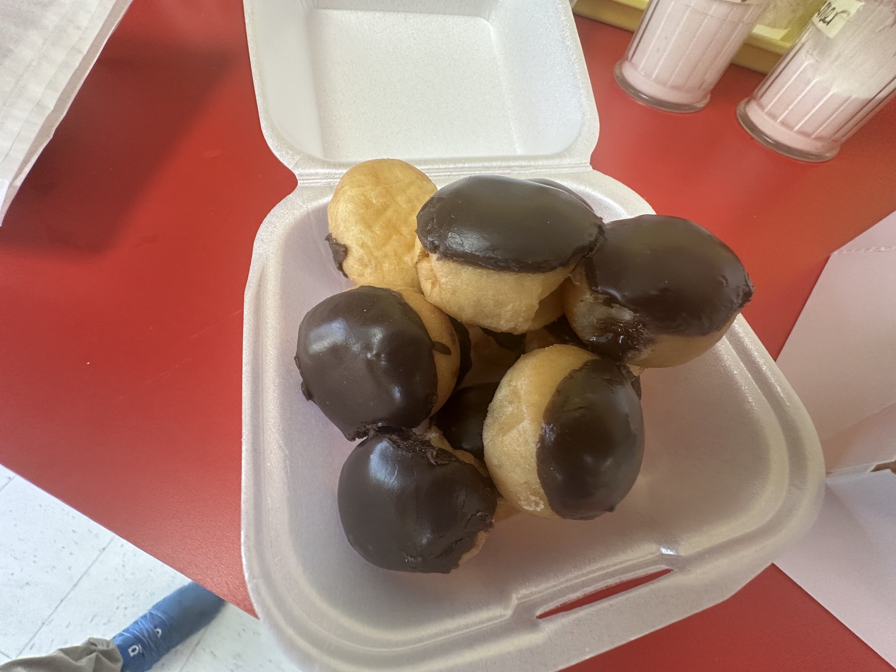 Chocolate-topped donut bites in a takeout container from Wow Donuts in Edmond