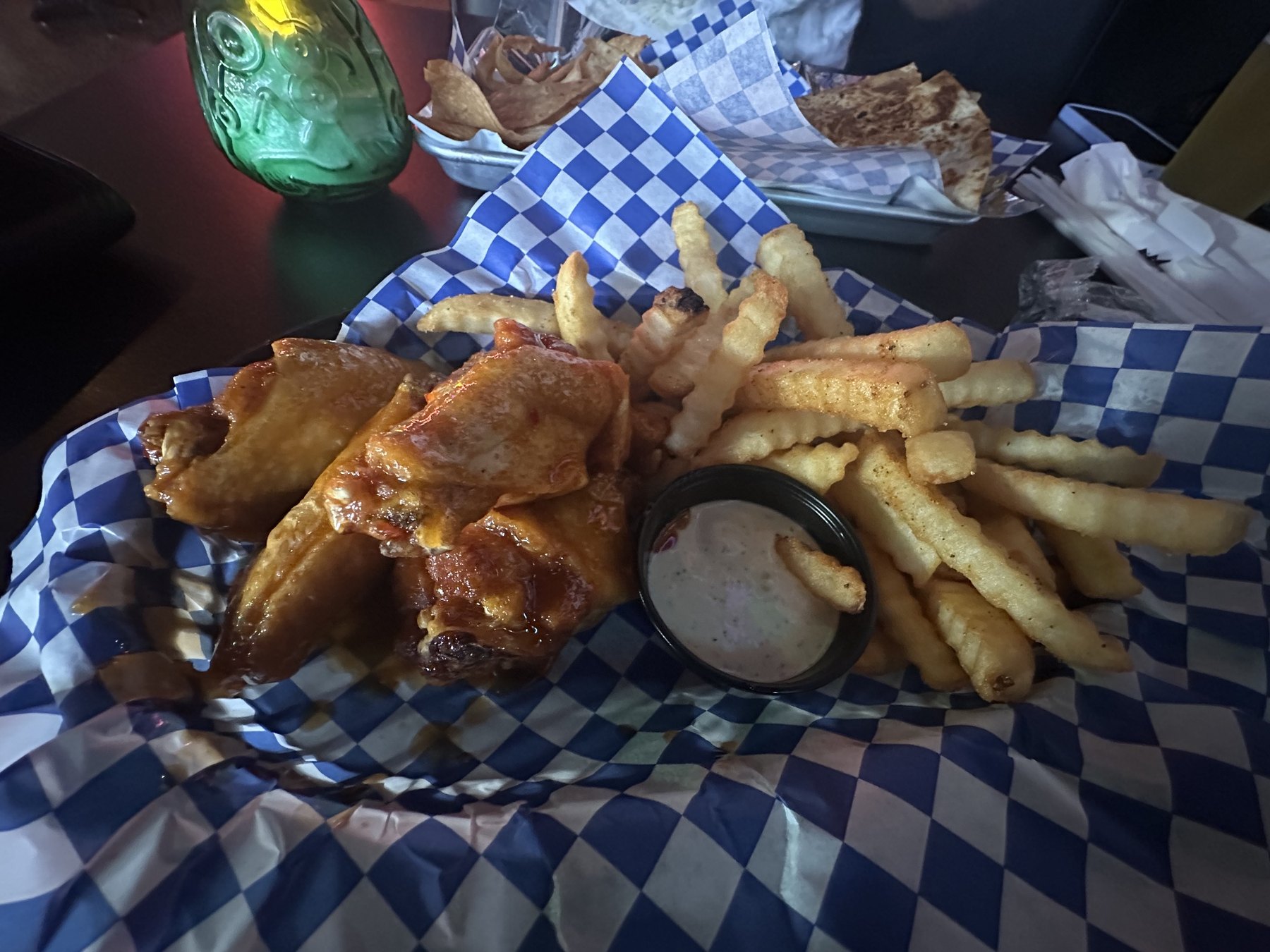 Sauced chicken wings with crinkle-cut fries and dipping sauce at Rad Bar in Oklahoma.