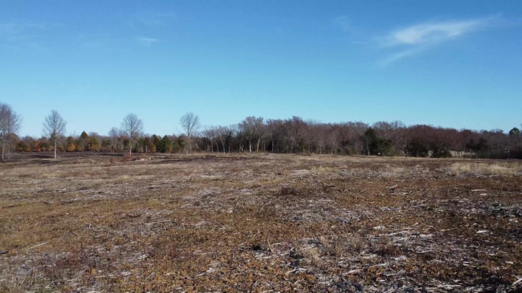 Open field and tree line at Honey Springs Battlefield in Oklahoma.