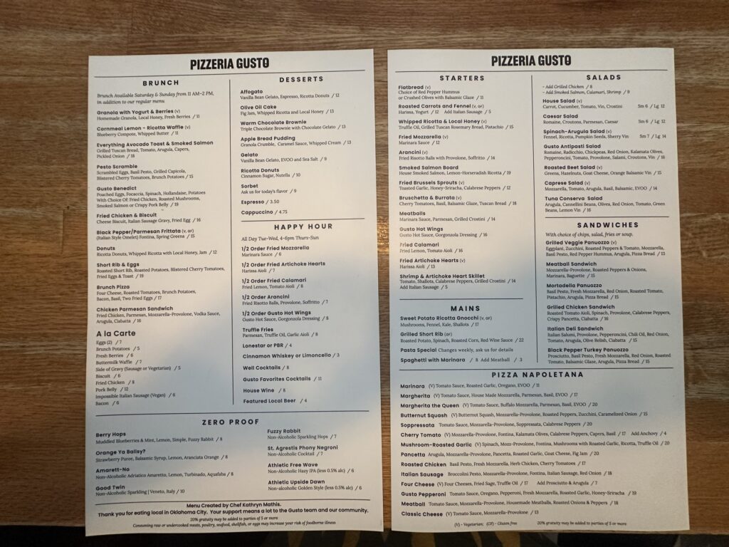 Printed Pizzeria Gusto menus showing brunch, starters, mains, sandwiches, and pizza options.
