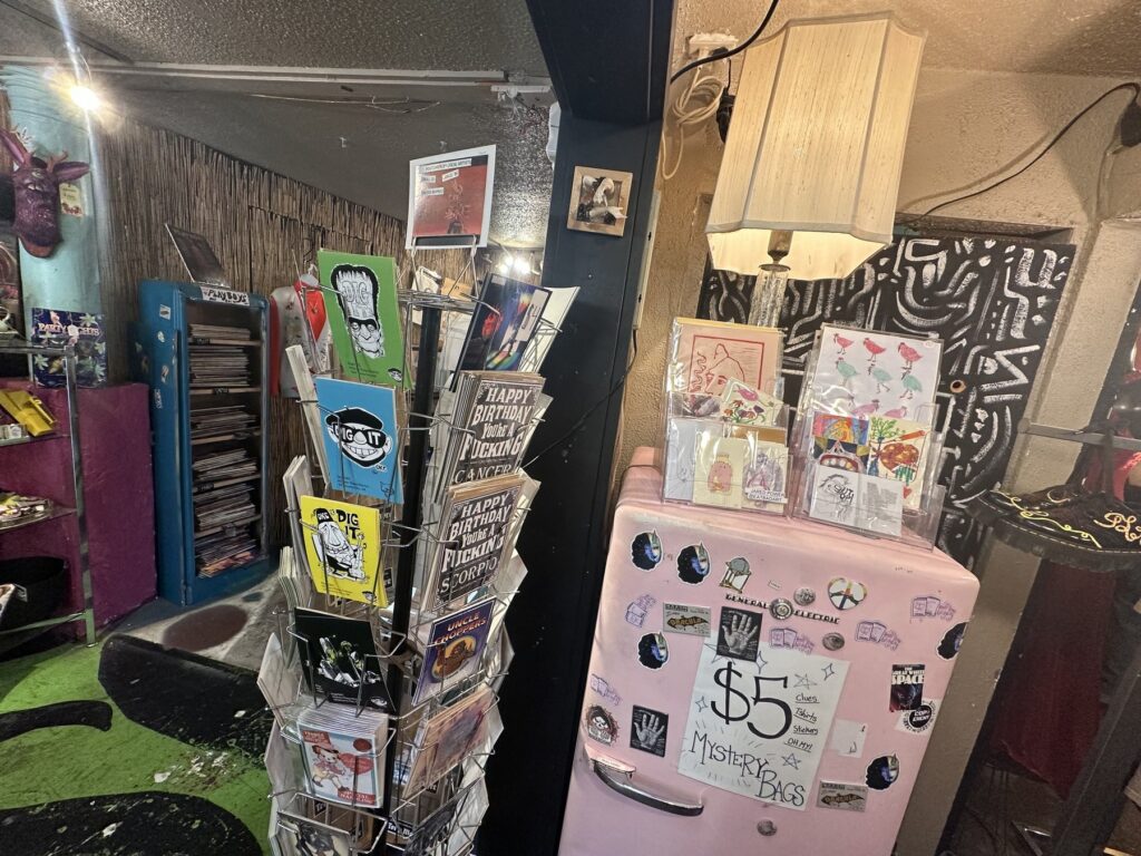 Greeting cards, stickers, art prints, and a pink mystery bag cabinet inside Dig It in Oklahoma City.