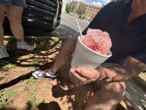 Red snowcone in a white cup held outside Josh’s Sno Shack in Stillwater
