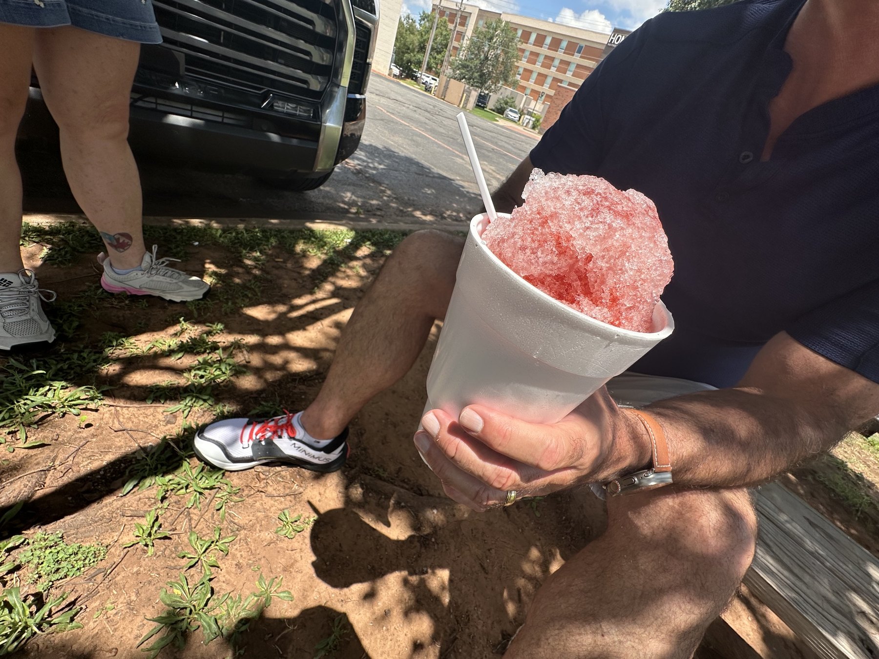 Red snowcone in a white cup held outside Josh’s Sno Shack in Stillwater