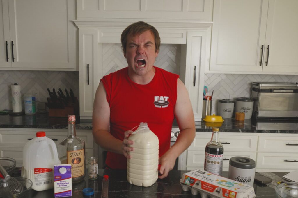 Cook shouting behind a large finished jug of homemade Fight Milk on a kitchen counter.