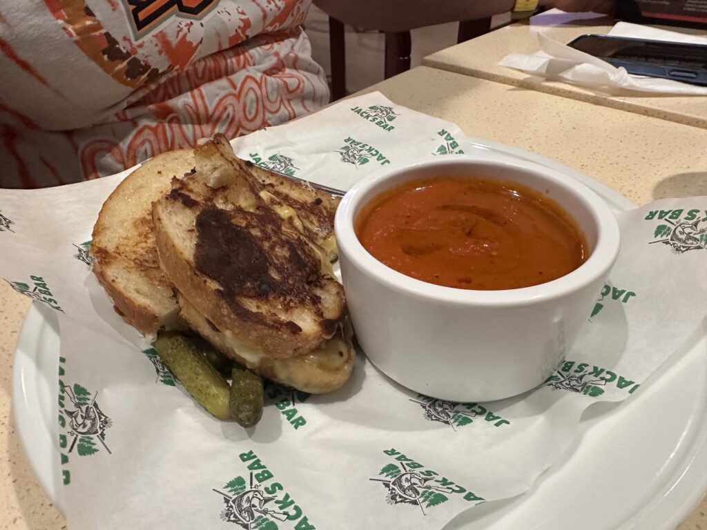 Grilled cheese sandwich with pickles and tomato soup at Netflix Bites Dallas