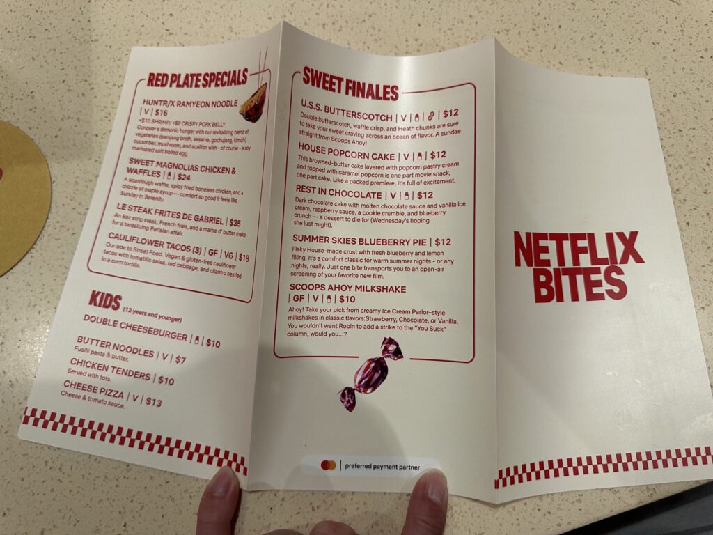 Netflix Bites Dallas menu showing red plate specials, kids items, desserts, and milkshakes