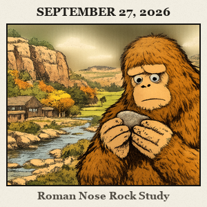 Bigfoot stands by canyon walls and cedar trees at Roman Nose State Park, holding a smooth river rock in both hands and studying it.