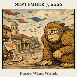 Bigfoot crouches behind a colorful stucco wall in the Paseo Arts District as banners flutter in a gusty street scene.