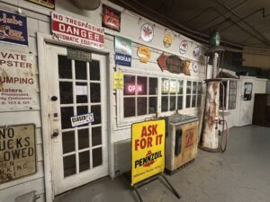 Retro service station display with old gas signs and a Pennzoil sign inside an Oklahoma City antique mall