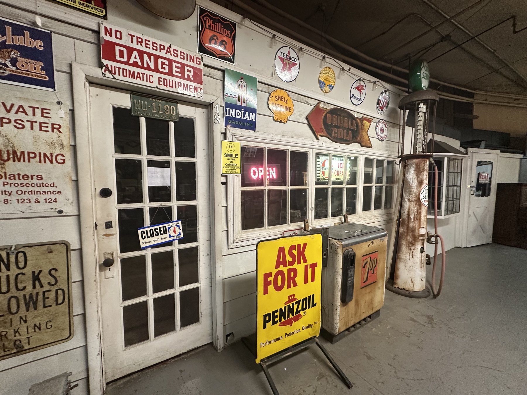 Retro service station display with old gas signs and a Pennzoil sign inside an Oklahoma City antique mall