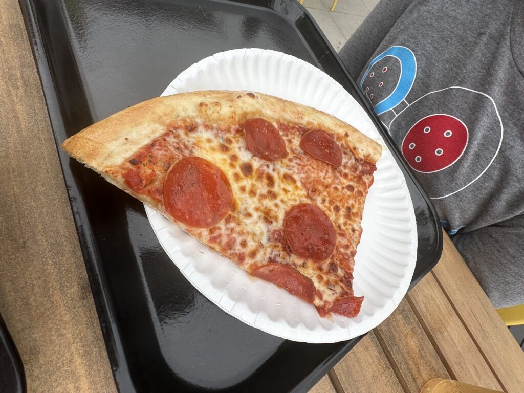 Large pepperoni pizza slice from Eastside Pizza House served on a paper plate