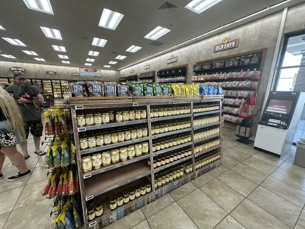 Snack aisle with chips, jars, and candy inside Buc-ee's in Denton