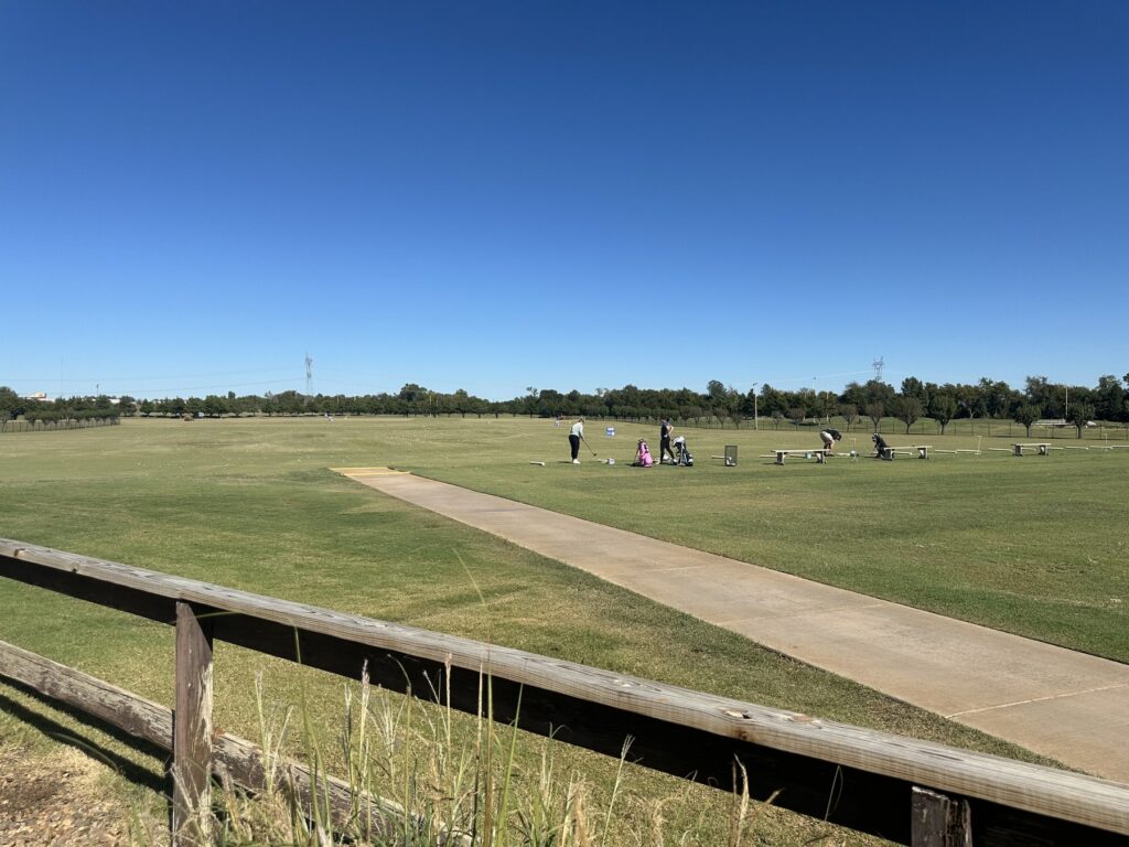Golfers practicing on the outdoor driving range at JR’s Pub and Grill in Oklahoma City.