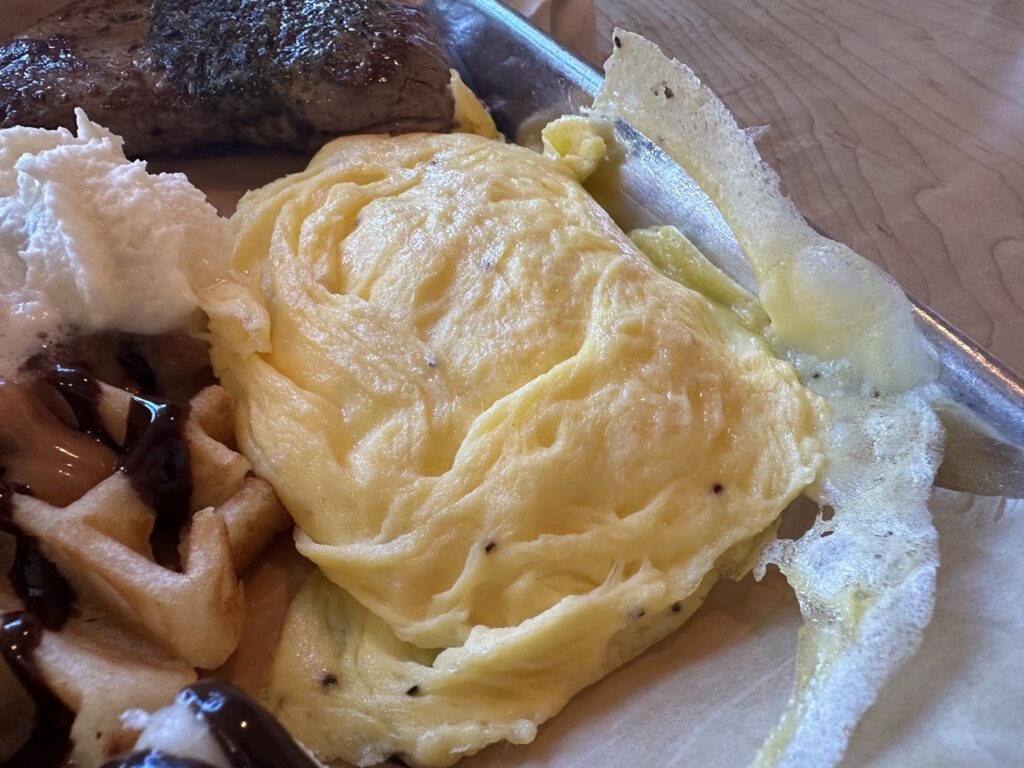 Close-up of eggs beside steak and waffle at Just Wafflin’ in Stillwater