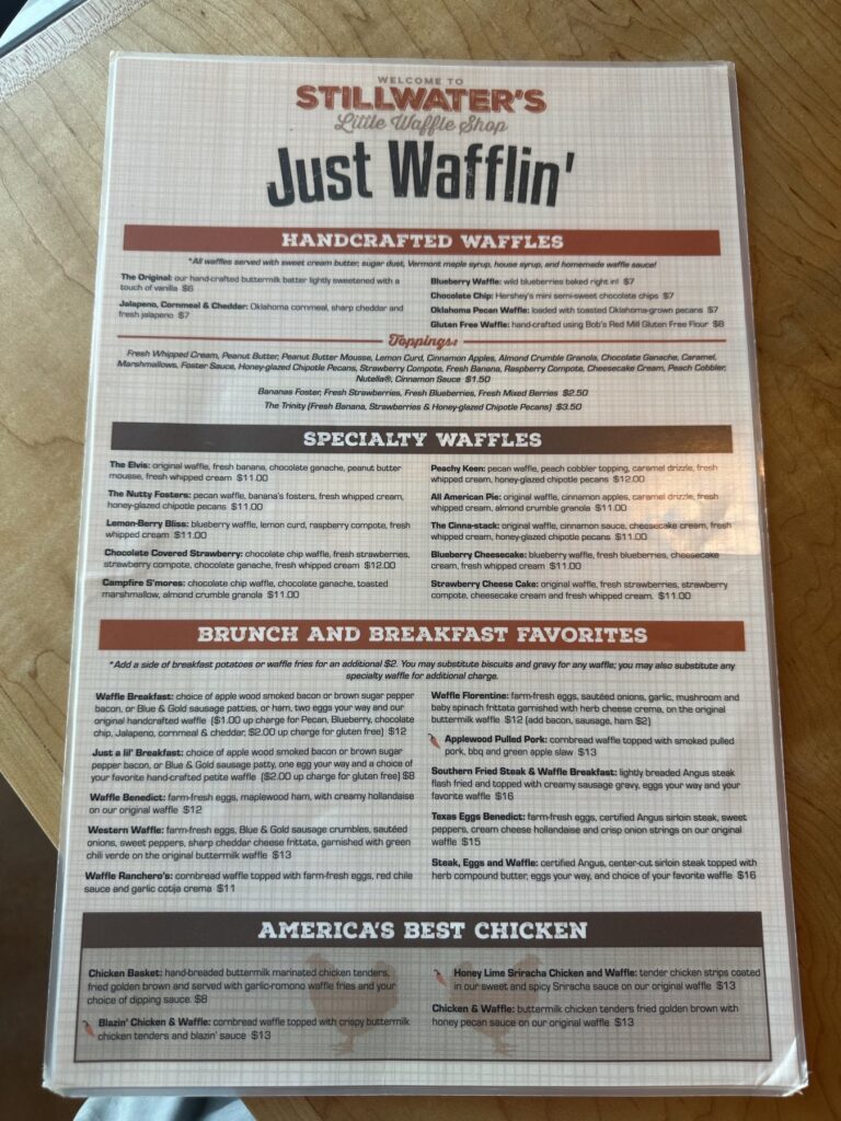 Just Wafflin’ menu page showing handcrafted waffles, specialty waffles, breakfast favorites, and chicken options