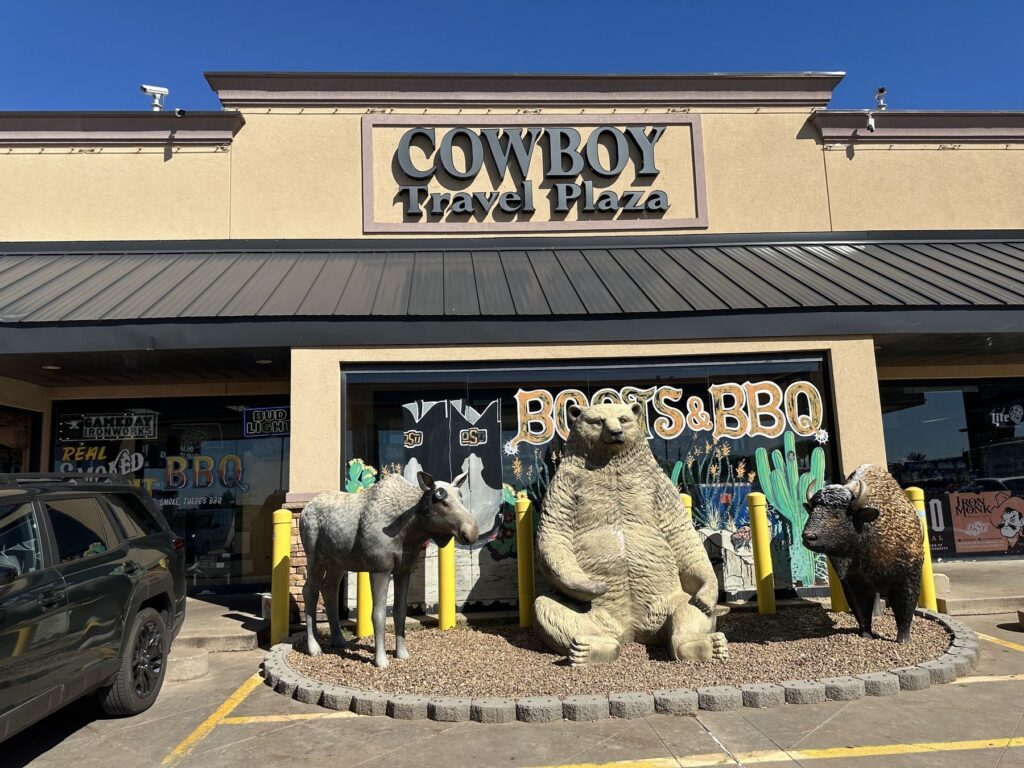 Exterior of Cowboy Travel Plaza in Oklahoma with large horse, bear, and bison statues by the entrance