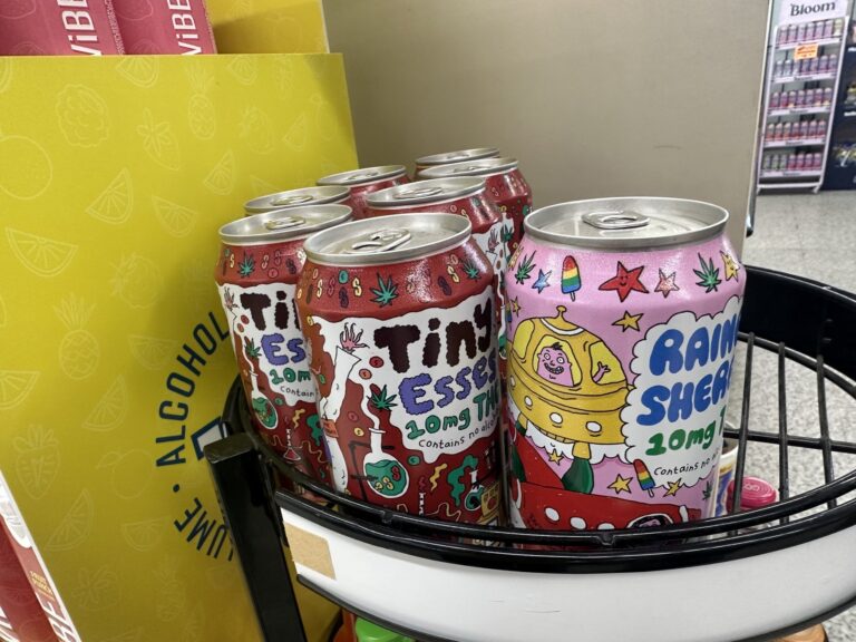 Colorful 10 mg THC beverage cans displayed inside Sweis Foods grocery market