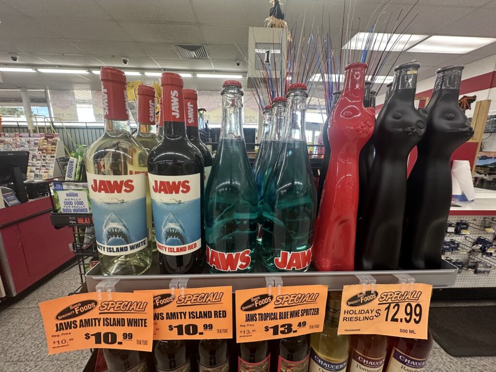 Jaws-themed wine bottles and specialty bottles displayed inside Sweis Foods