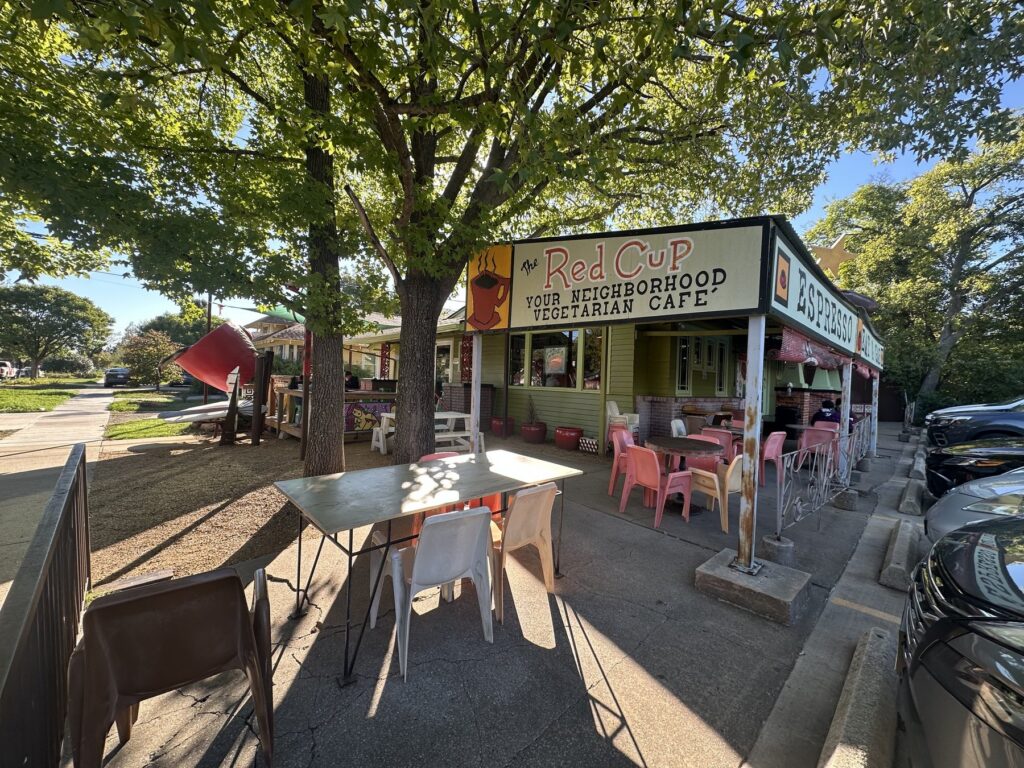 Exterior patio and sign for The Red Cup, a neighborhood vegetarian cafe in OKC.