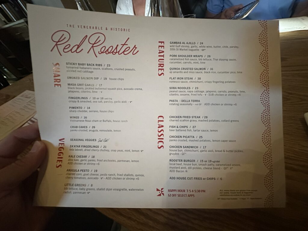 Printed Red Rooster menu showing shareables, vegetables, features, classics, and happy hour items.