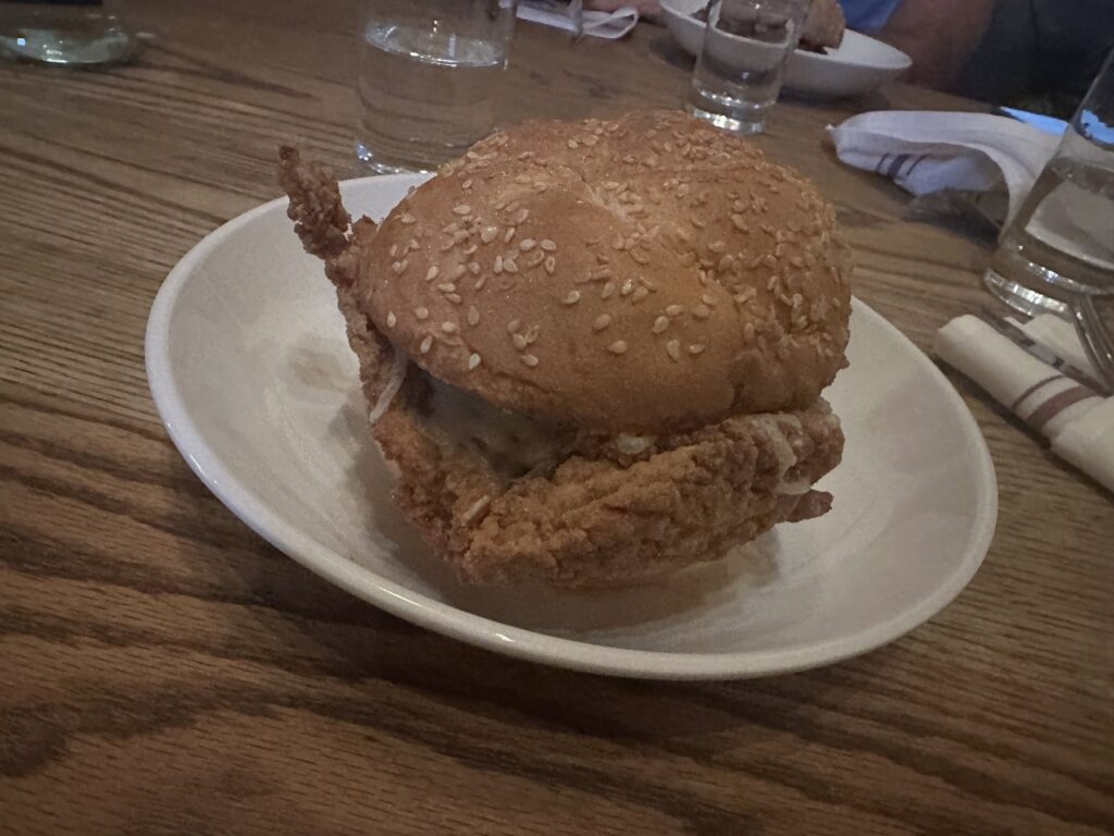 Fried chicken sandwich on a sesame bun at Red Rooster in Oklahoma City.