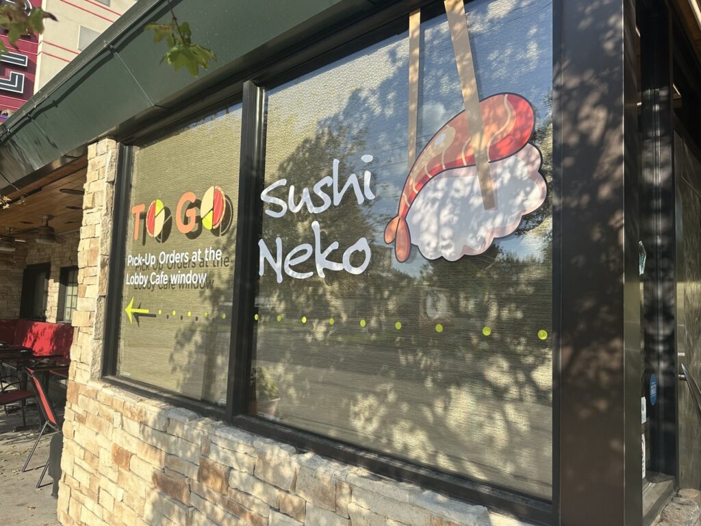 Sushi Neko window signage with to-go pickup instructions.